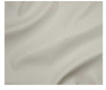 A close-up of draped off-white fabric with soft folds and a smooth texture.