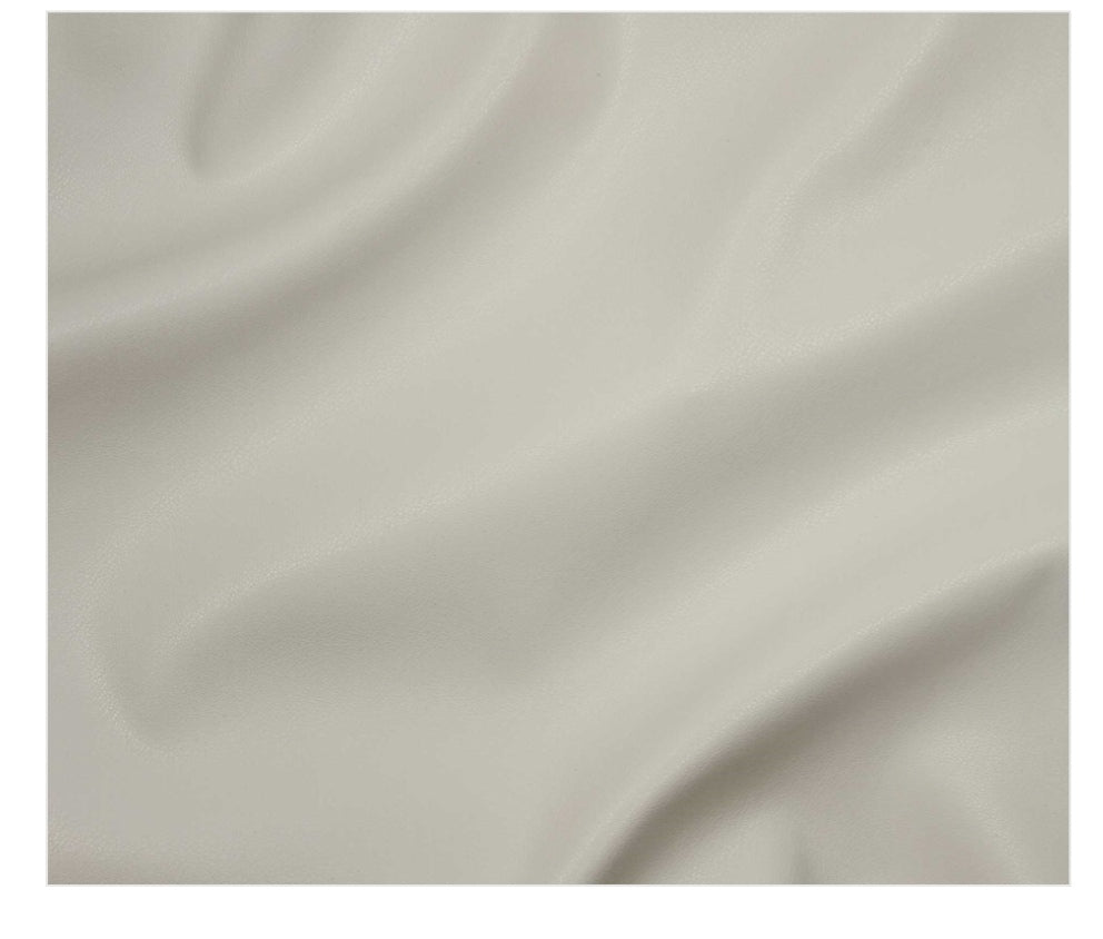 A close-up of draped off-white fabric with soft folds and a smooth texture.