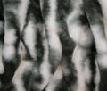 A close-up of faux fur fabric with a black and white mottled pattern, showing the soft texture and vertical folds.